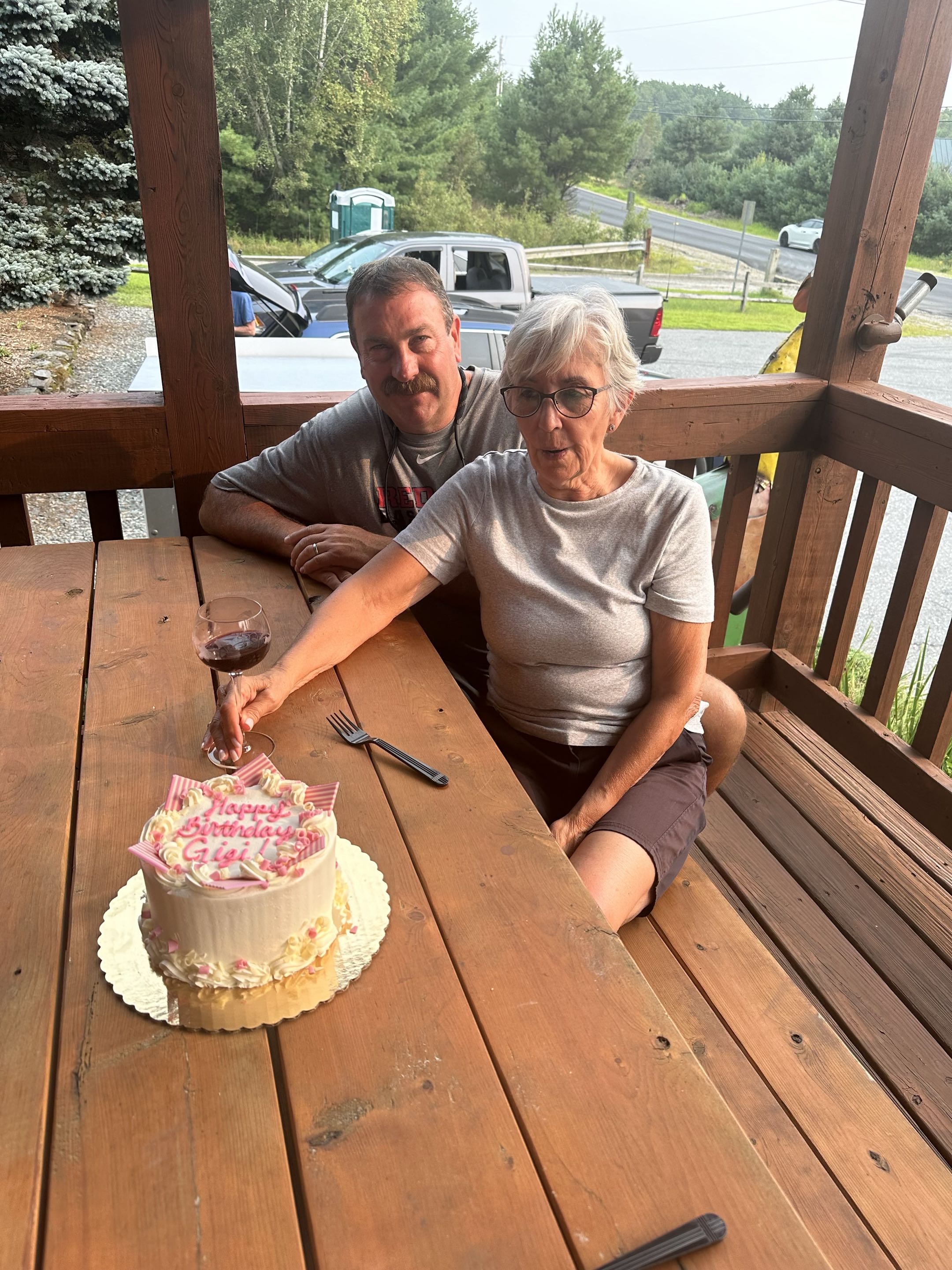 Guests celebrating with cake on the porch